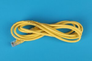 Yellow coaxial cable on a bright blue background